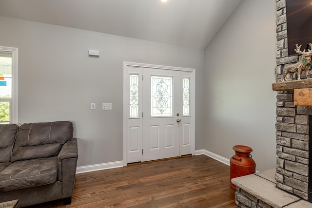 foyer entrance with dark hardwood / wood-style floors and lofted ceiling