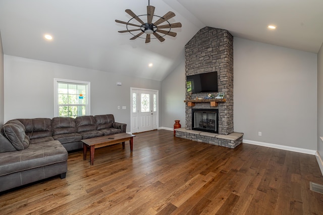 living room with a fireplace, hardwood / wood-style flooring, and baseboards