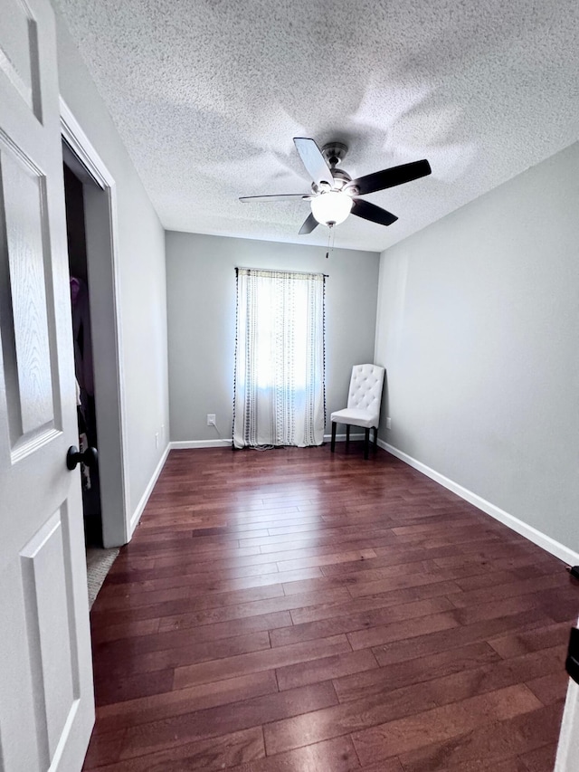 unfurnished room with ceiling fan, wood-type flooring, and a textured ceiling