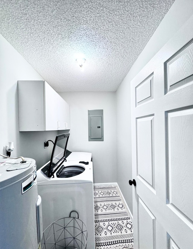 laundry area with water heater, cabinets, a textured ceiling, electric panel, and independent washer and dryer