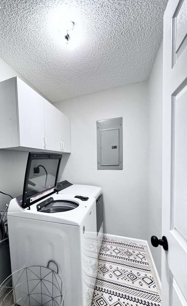231 Hatfield St, Corbin, KY 40701 - laundry room featuring electric panel, a textured ceiling, washing machine and dryer, cabinet space, and baseboards