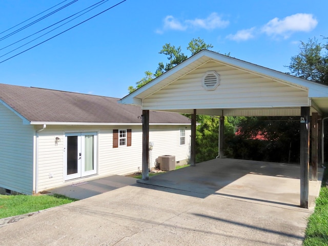 view of front of house featuring a carport, cooling unit, and french doors