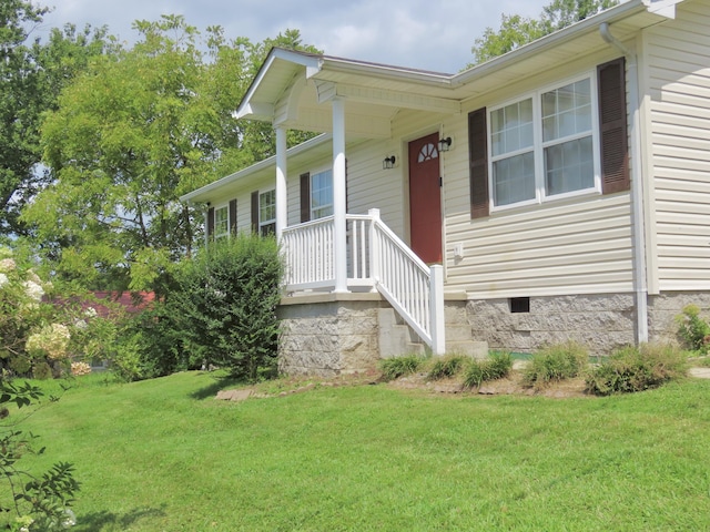 231 Hatfield St, Corbin, KY 40701 - view of exterior entry featuring crawl space and a yard