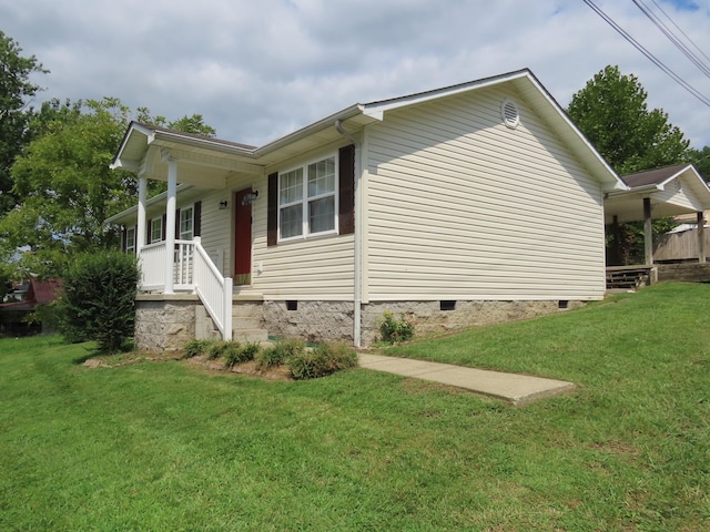 view of side of home featuring a lawn