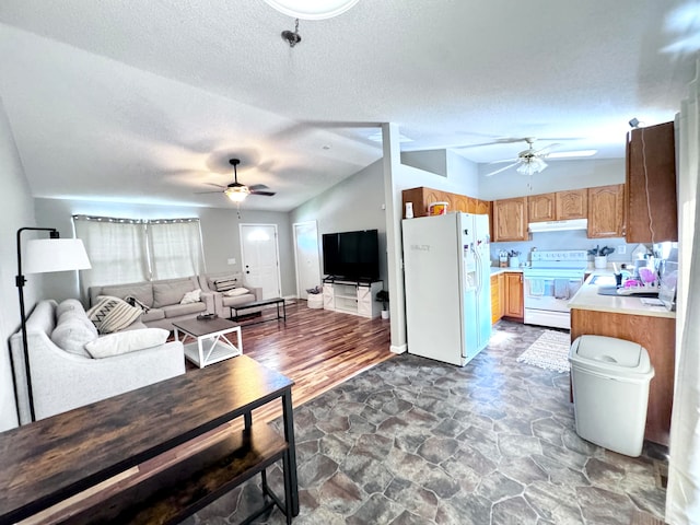 living room featuring ceiling fan, dark hardwood / wood-style floors, sink, a textured ceiling, and lofted ceiling