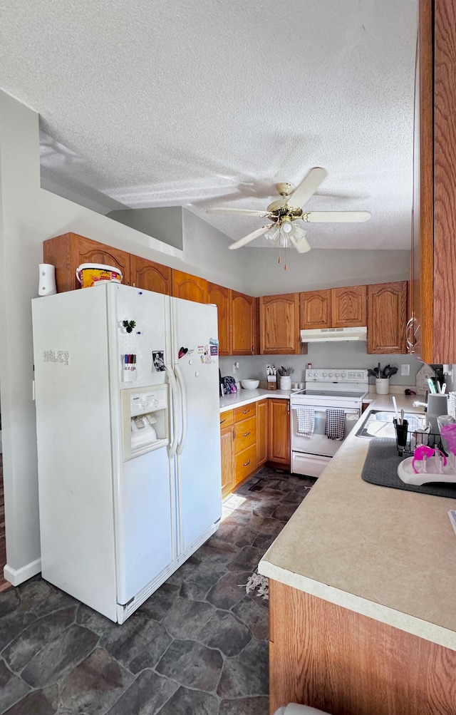 kitchen with ceiling fan, dark tile patterned flooring, a textured ceiling, and white appliances