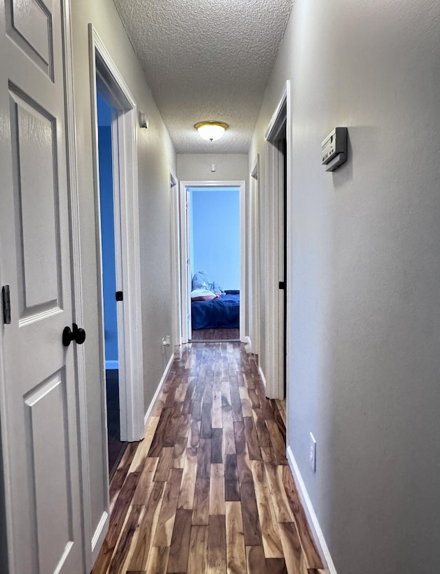 231 Hatfield St, Corbin, KY 40701 - hall with a textured ceiling, dark wood-style floors, and baseboards
