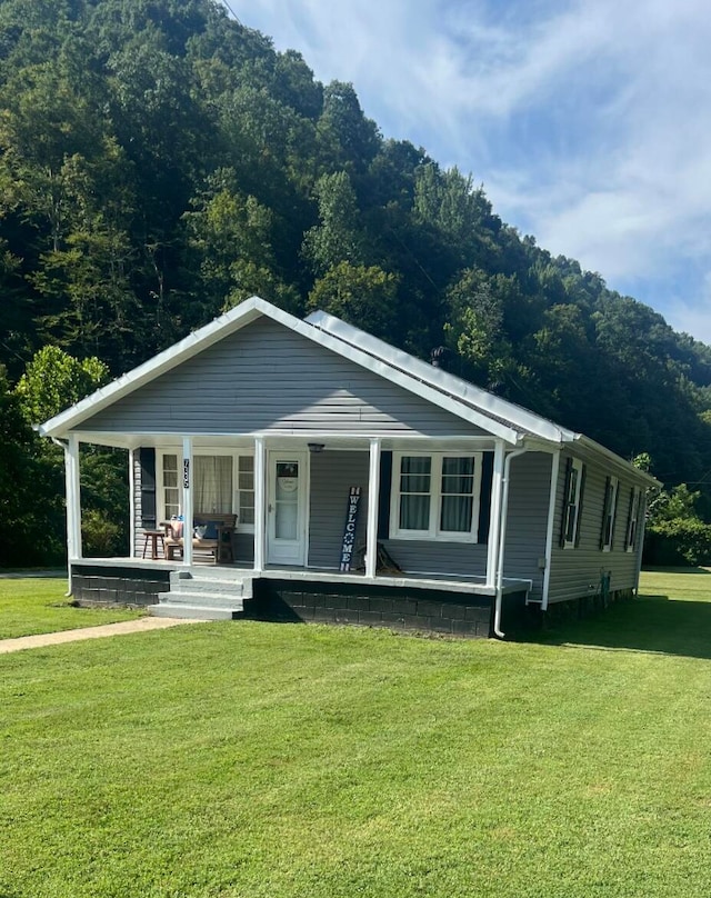 view of front of property with a porch and a front yard