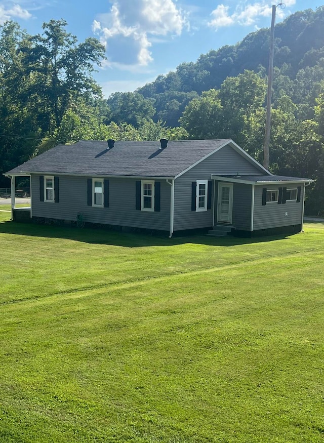 ranch-style home with a front lawn