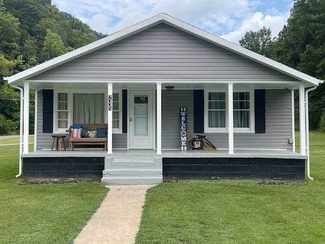 bungalow-style home with a porch and a front lawn