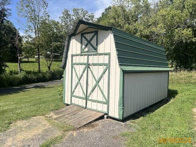 view of outbuilding with a yard