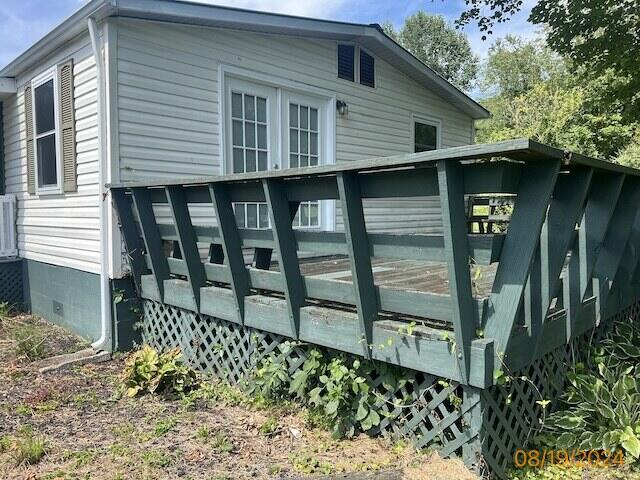 view of property exterior featuring a wooden deck