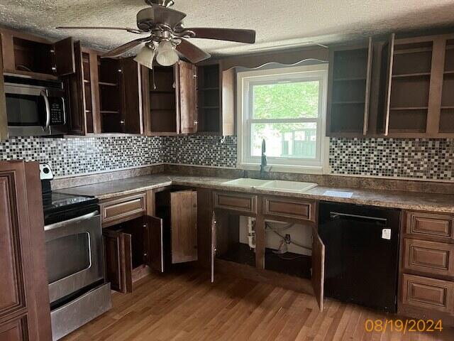 kitchen featuring sink, tasteful backsplash, hardwood / wood-style flooring, and stainless steel appliances