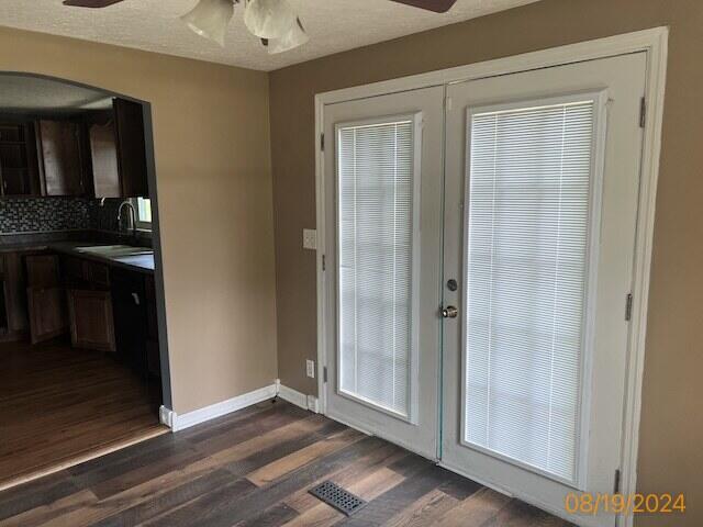 doorway with ceiling fan, dark hardwood / wood-style floors, sink, and french doors