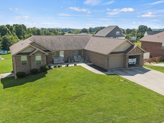 ranch-style house featuring a garage and a front lawn