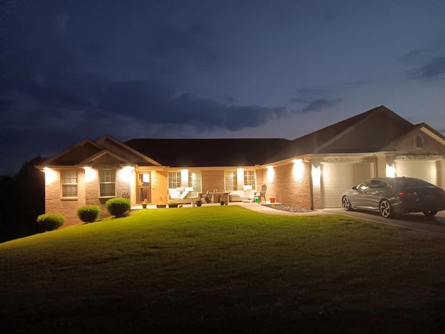 view of front facade with a garage and a lawn