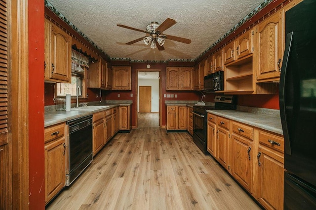 8594 Morehead Rd, Flemingsburg, KY 41041 - kitchen with light wood-type flooring, black appliances, brown cabinets, and a sink