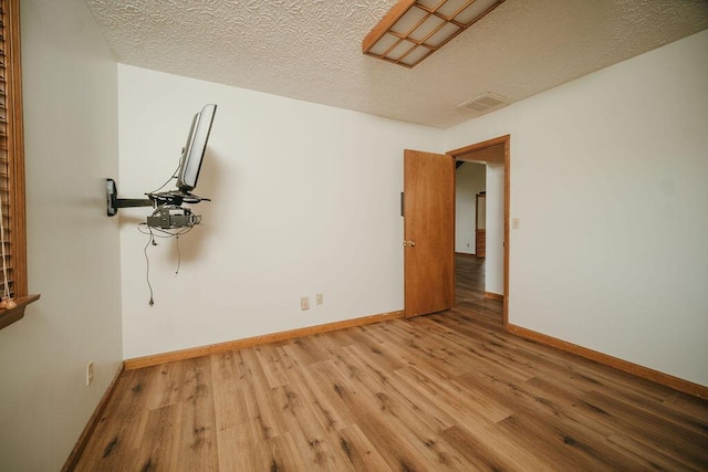 8594 Morehead Rd, Flemingsburg, KY 41041 - unfurnished room featuring light wood-type flooring, baseboards, and a textured ceiling