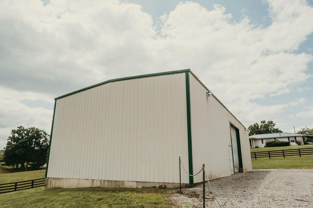 8594 Morehead Rd, Flemingsburg, KY 41041 - view of property exterior with a garage, fence, an outdoor structure, and gravel driveway