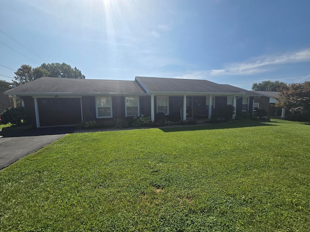 single story home featuring a garage and a front lawn