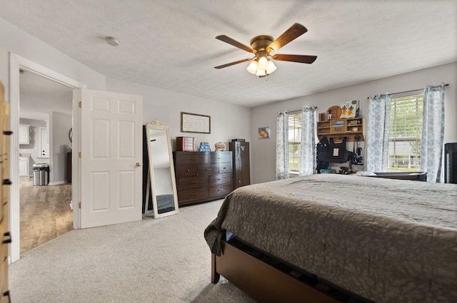 bedroom featuring carpet flooring, ceiling fan, and multiple windows