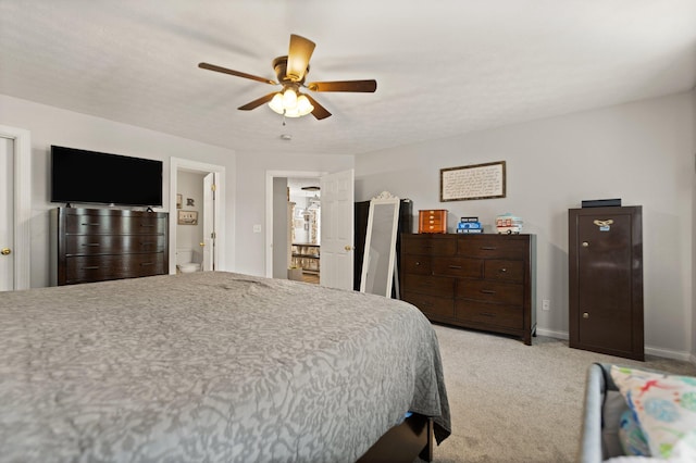 carpeted bedroom featuring ceiling fan and connected bathroom