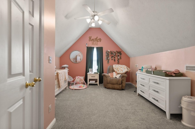 sitting room with ceiling fan, carpet flooring, and vaulted ceiling