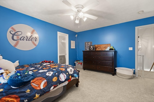 carpeted bedroom with ceiling fan and ensuite bath