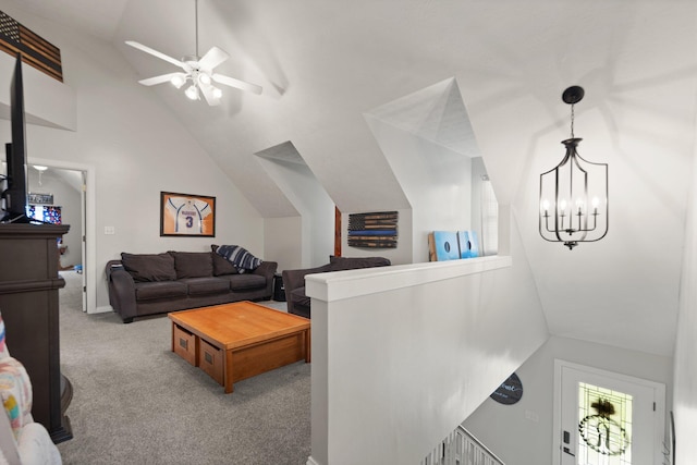 living room with carpet floors, ceiling fan with notable chandelier, and vaulted ceiling