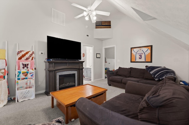 living room featuring high vaulted ceiling, ceiling fan, and light colored carpet