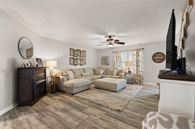 living room with ceiling fan and hardwood / wood-style flooring