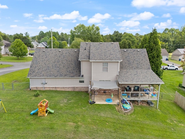 back of house with a patio area and a yard