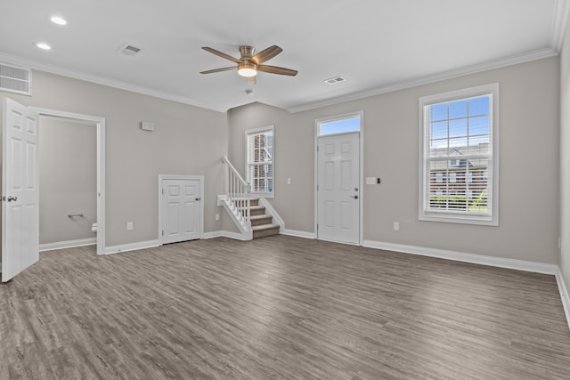 interior space featuring visible vents, stairway, wood finished floors, and ornamental molding