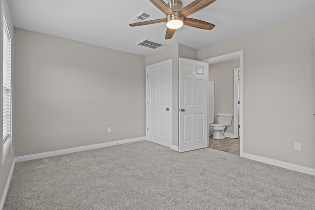 unfurnished bedroom with carpet floors, visible vents, and baseboards