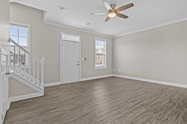 foyer featuring dark wood finished floors, crown molding, visible vents, ceiling fan, and stairs