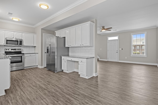 kitchen featuring white cabinetry, baseboards, appliances with stainless steel finishes, dark wood-style floors, and crown molding