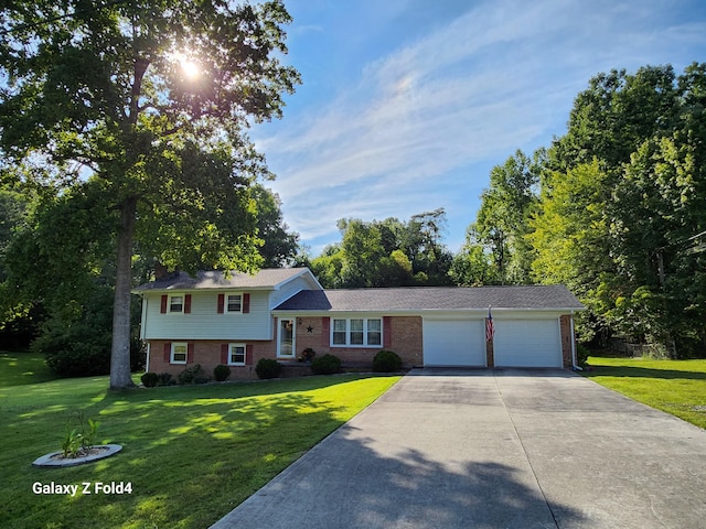 split level home with a garage and a front yard