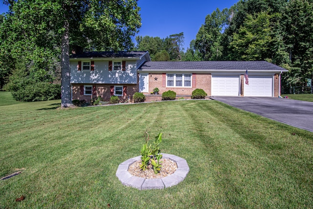 split level home with a garage and a front lawn