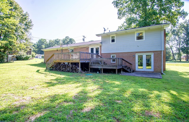 rear view of property featuring french doors, a deck, and a lawn