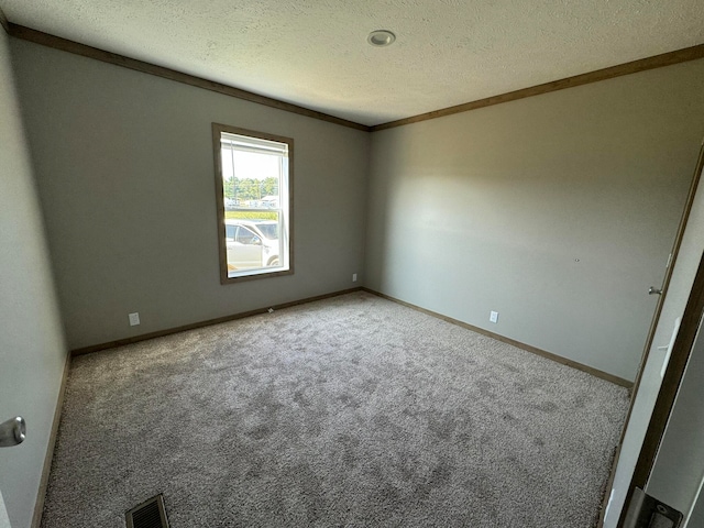 carpeted spare room with a textured ceiling and crown molding