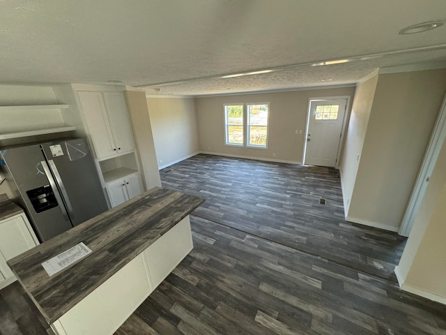 interior space with a textured ceiling and dark hardwood / wood-style floors