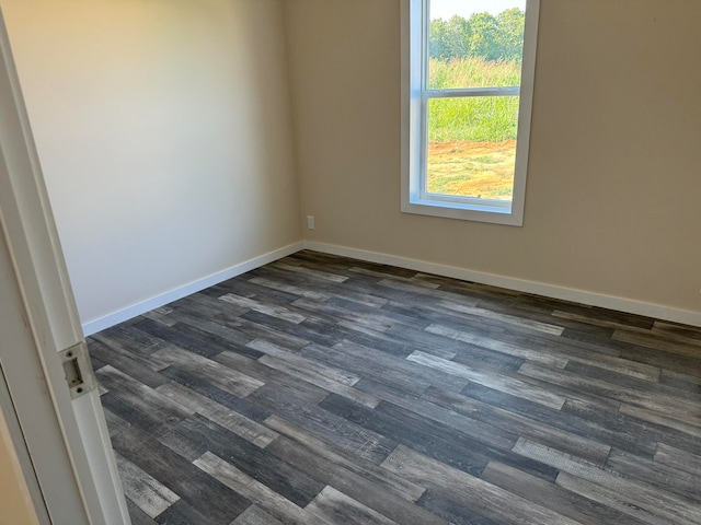 spare room featuring dark wood-type flooring