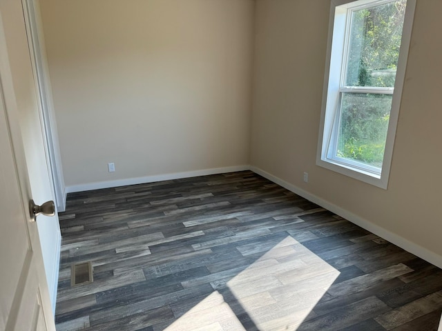 unfurnished room featuring dark hardwood / wood-style floors