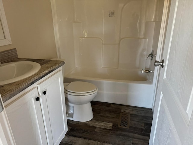 full bathroom with vanity, toilet,  shower combination, and wood-type flooring