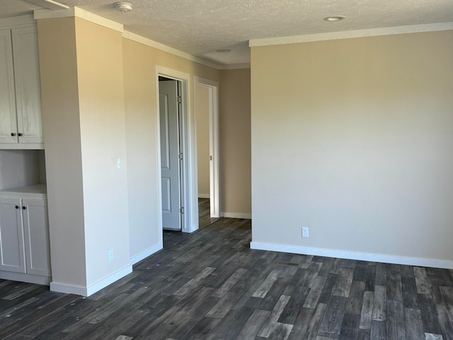 unfurnished room featuring ornamental molding, dark hardwood / wood-style flooring, and a textured ceiling