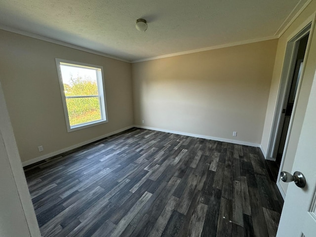 empty room featuring dark wood-type flooring, a textured ceiling, and ornamental molding