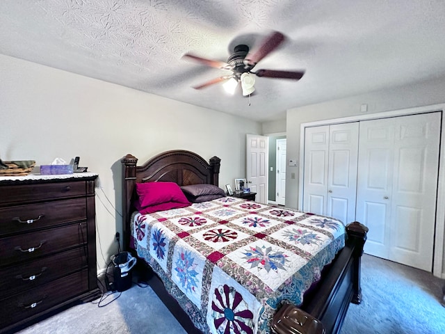 bedroom with a closet, ceiling fan, light carpet, and a textured ceiling