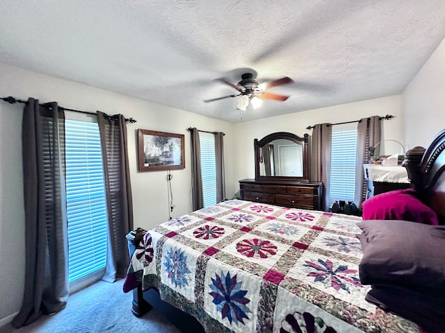 bedroom with a textured ceiling, ceiling fan, and carpet flooring