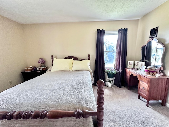 bedroom with light carpet and a textured ceiling