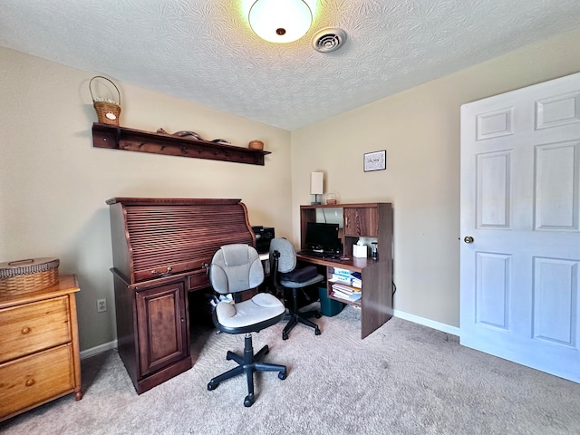 carpeted home office with a textured ceiling